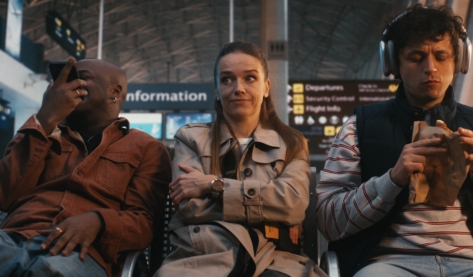 Three passengers in a public transit terminal demonstrating a variety of strategies to manage a stressful environment with the middle passenger representing an example of Autistic masking
